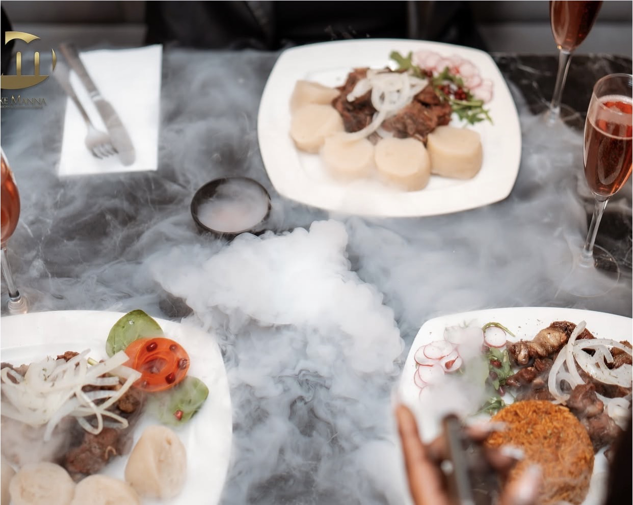 Congolese grilled dishes, rice and cassava bread served around a celebration table
